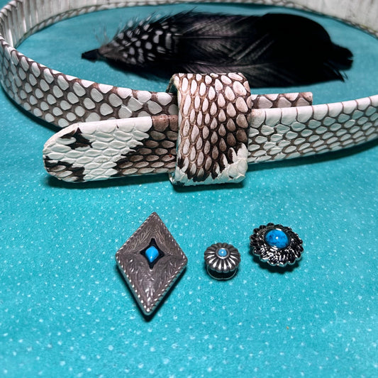 Silver belt with snake skin pattern and decorative elements on a blue background