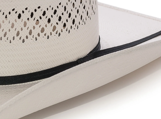 Close-up of a cream traditional cowboy hat with black ribbon tie band on a white background